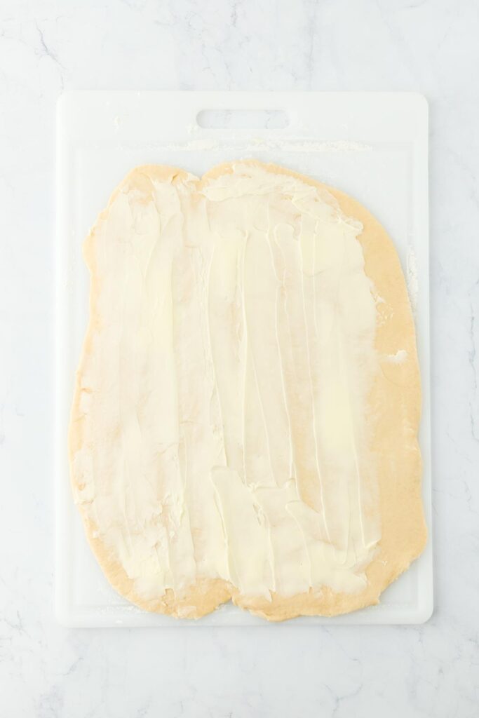 Dough rolled out with butter spread over the surface, ready for the filling