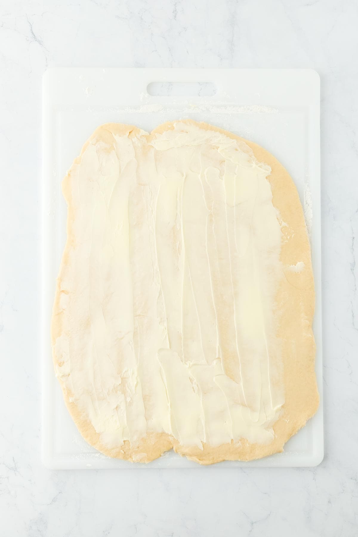 Dough rolled out with butter spread over the surface, ready for the filling