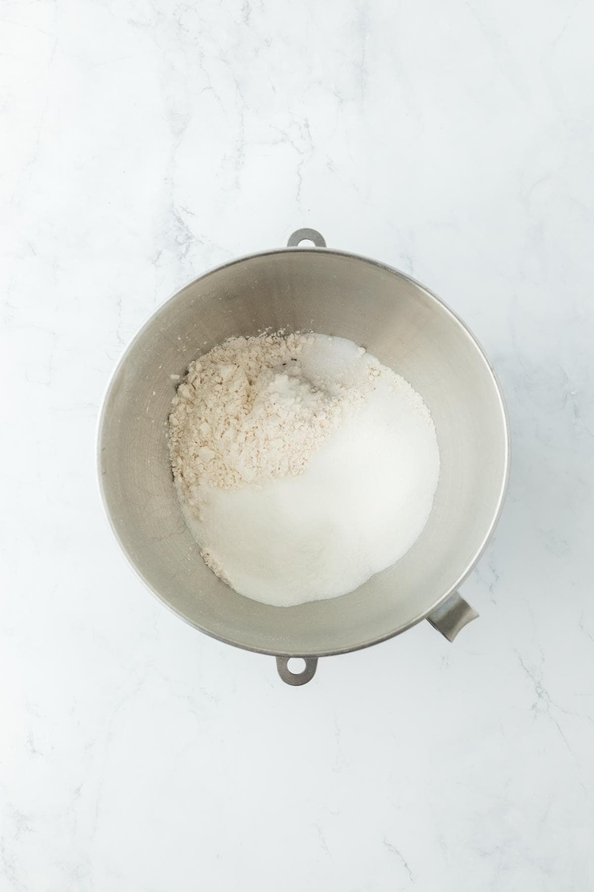 A mixing bowl with dry ingredients