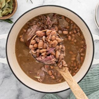 A big bowl of pinto beans with a spoon ready to eat