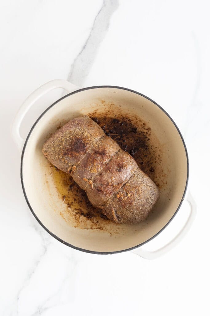 A roast in a dutch oven being seared
