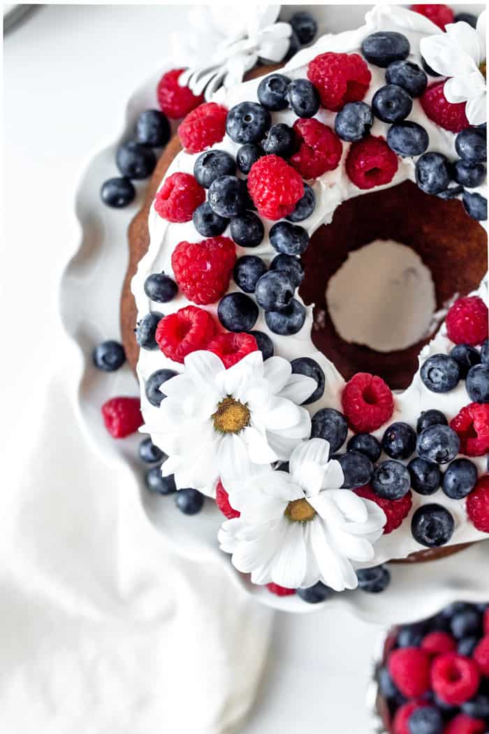 Close up overhead of Old Fashioned Pound Cake with raspberries and blueberries on top as garnish