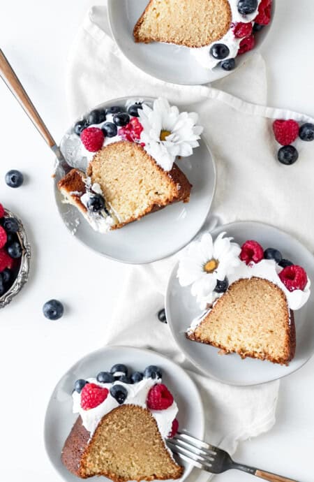 Slices of butter pound cake on white plates ready to serve