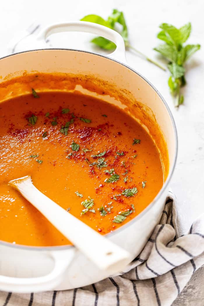 A large pot of carrot soup ready to serve