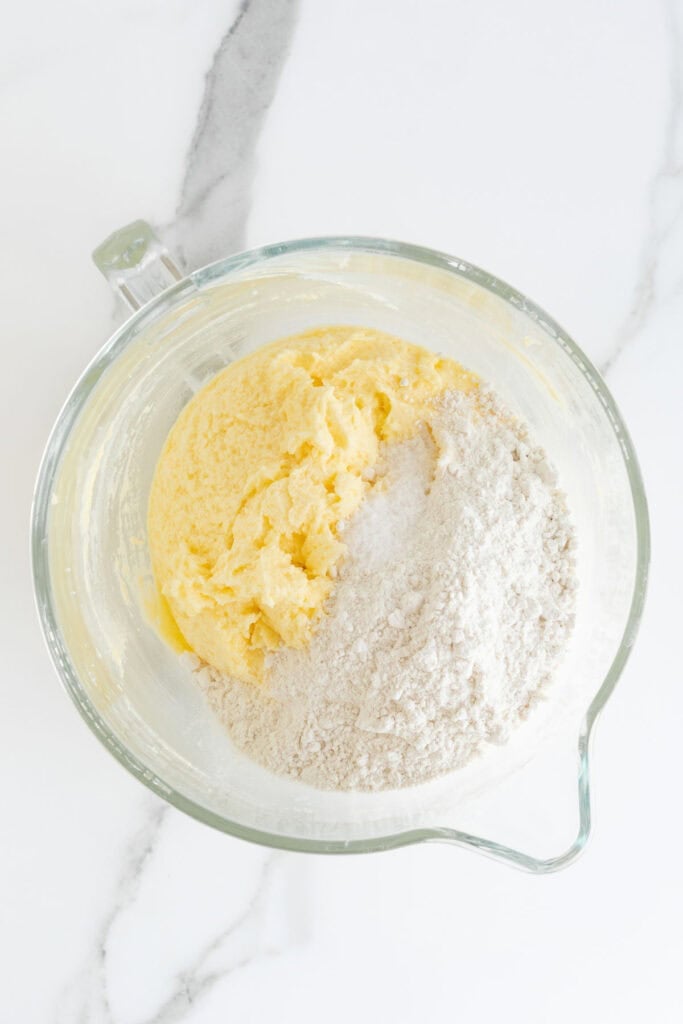 Flour added to butter pound cake batter in a stand mixer