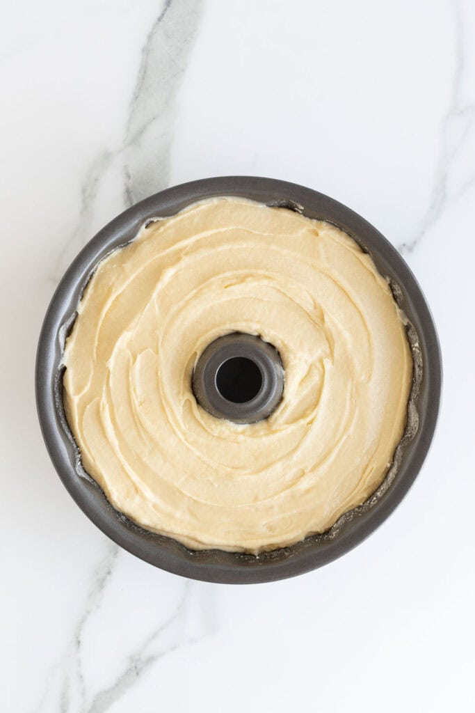 Butter pound cake batter added to greased bundt pan