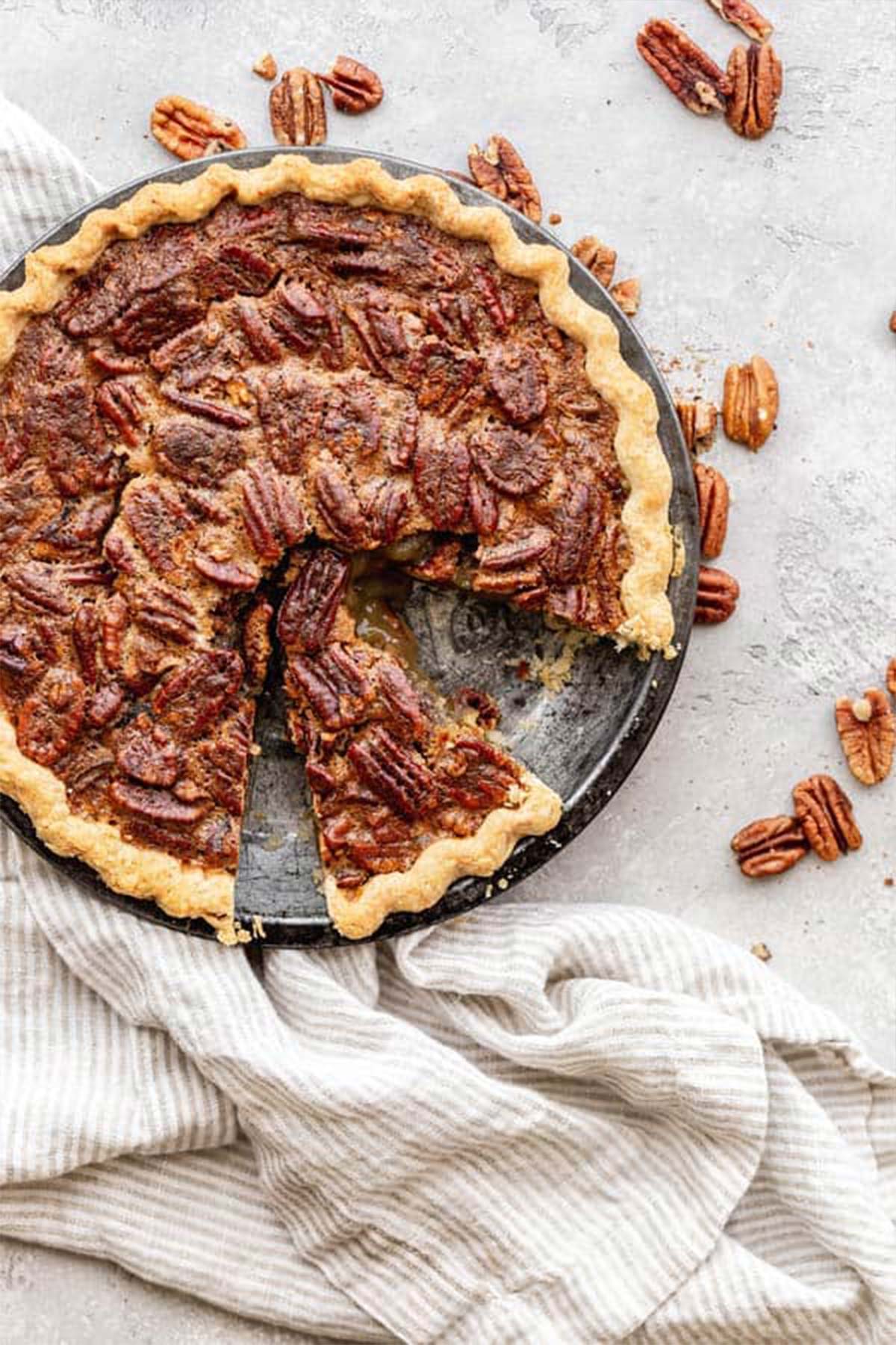 A freshly baked pecan pie with slices ready to serve