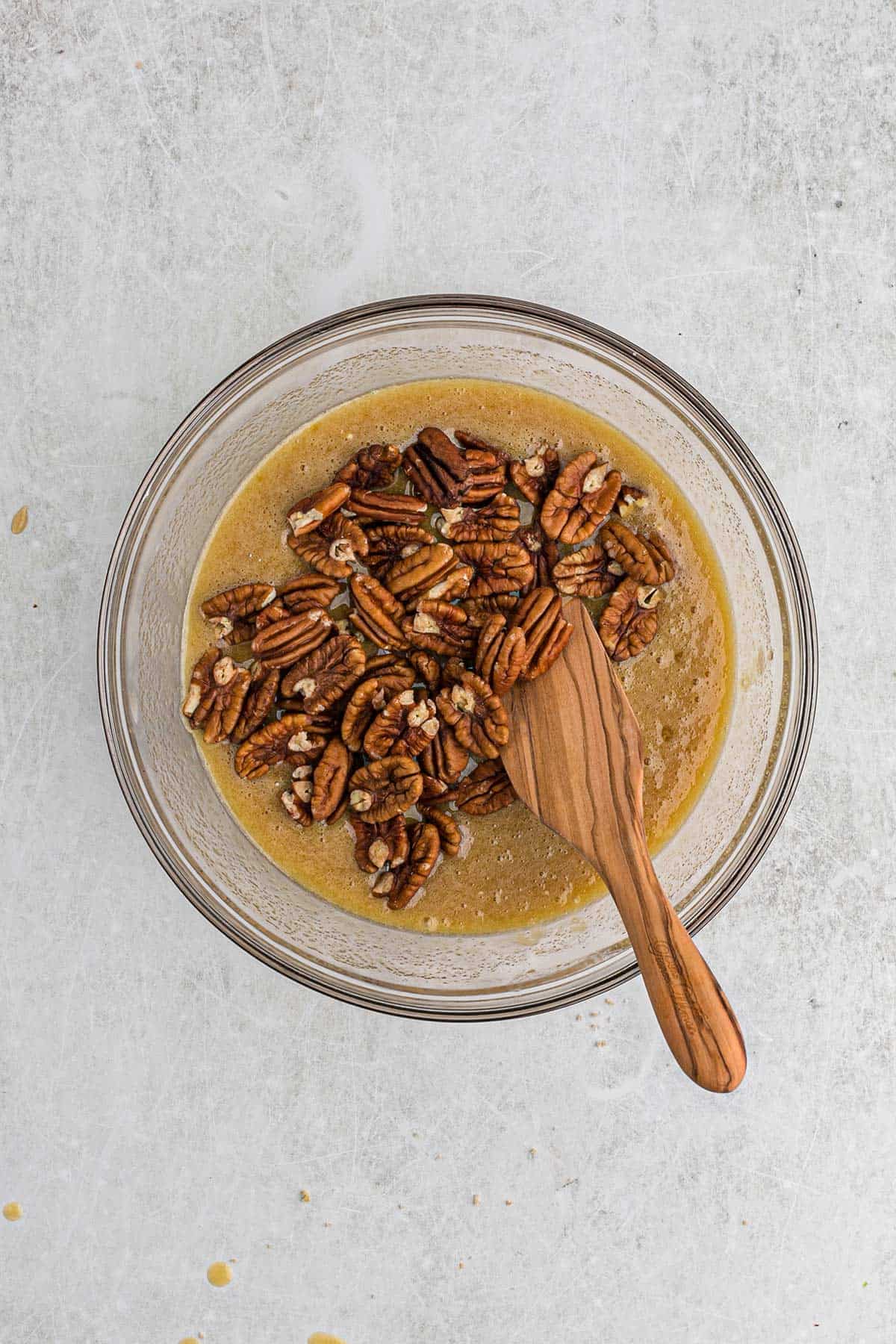 Pecans added to the pie filling mixture on countertop