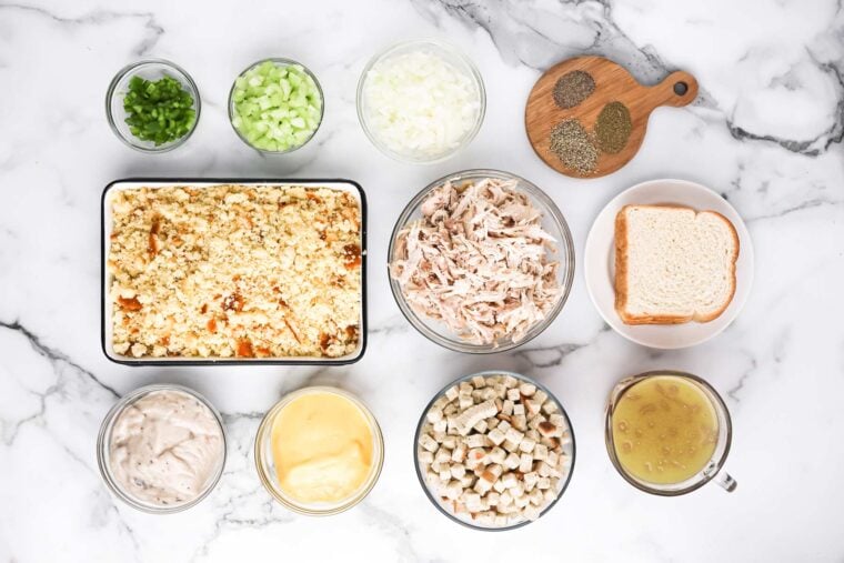 Ingredients to make southern cornbread dressing recipe on the white countertop .