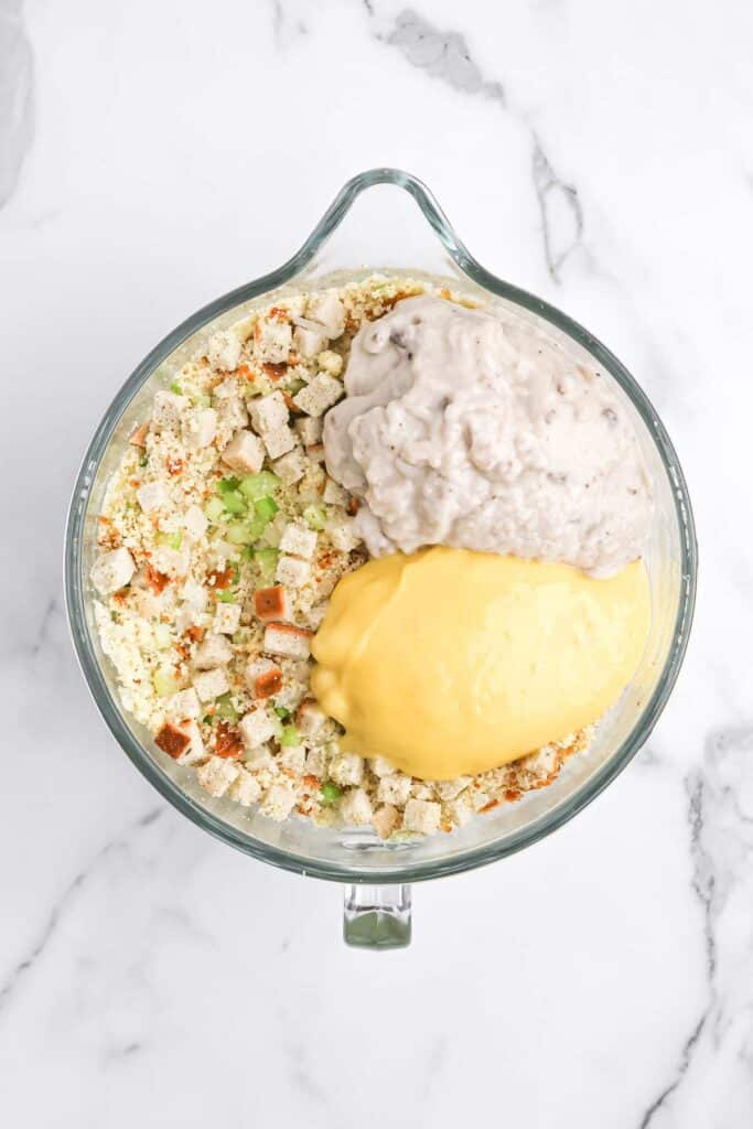 Old fashioned dressing ingredients in a mixing bowl on white countertop