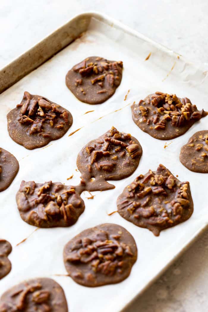 A sheet pan filled with pralines recipe cooling