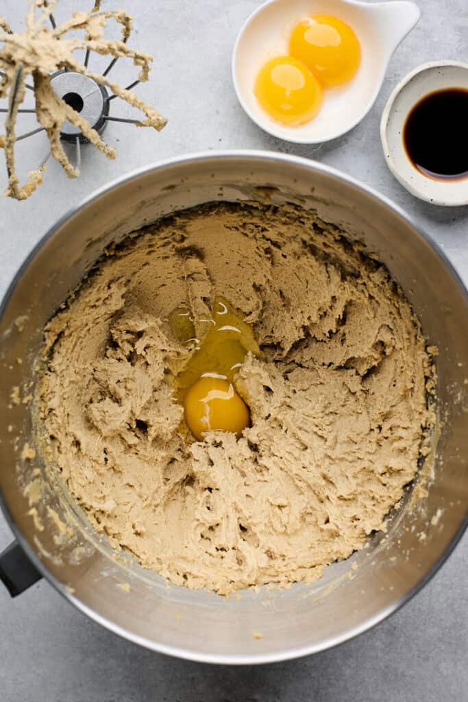 Eggs being added to cookie dough before mixing
