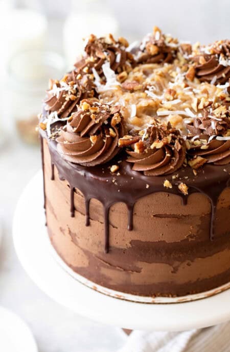 Close up of German Chocolate Cake icing on cake with ganache dripping down