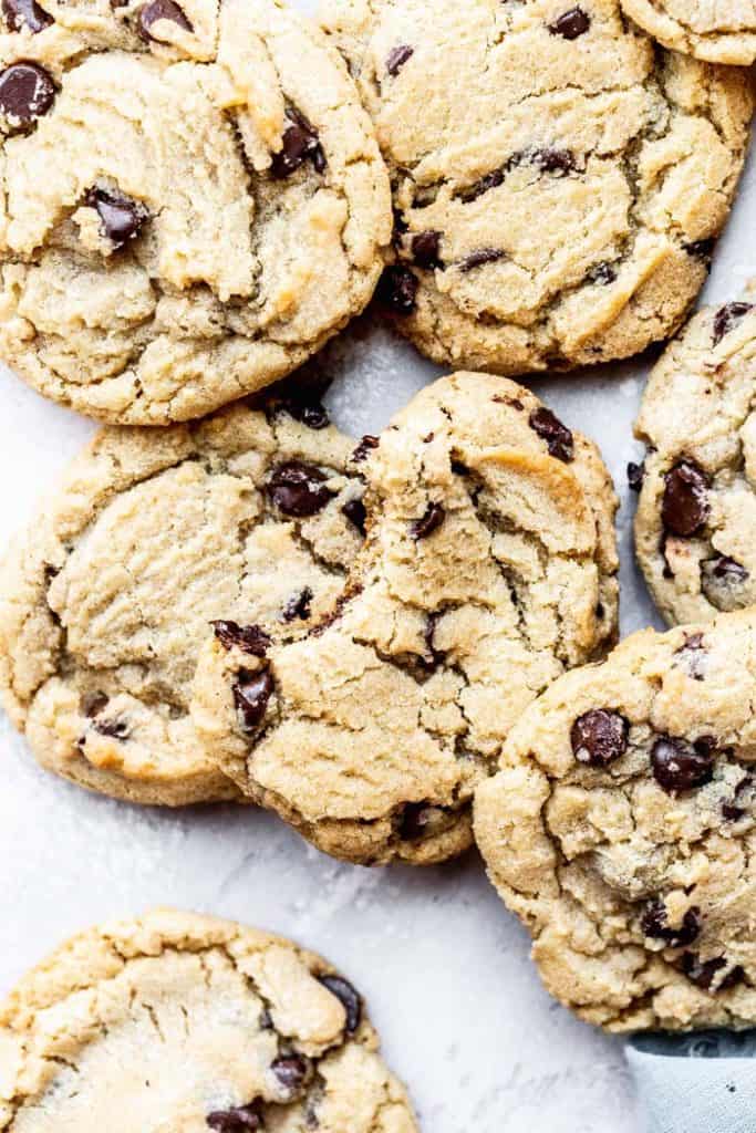 Gluten Free Chocolate Chip Cookies ready to eat scattered around in a kitchen