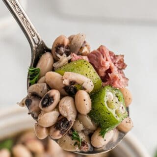 A spoonful of black eyed peas with ham.