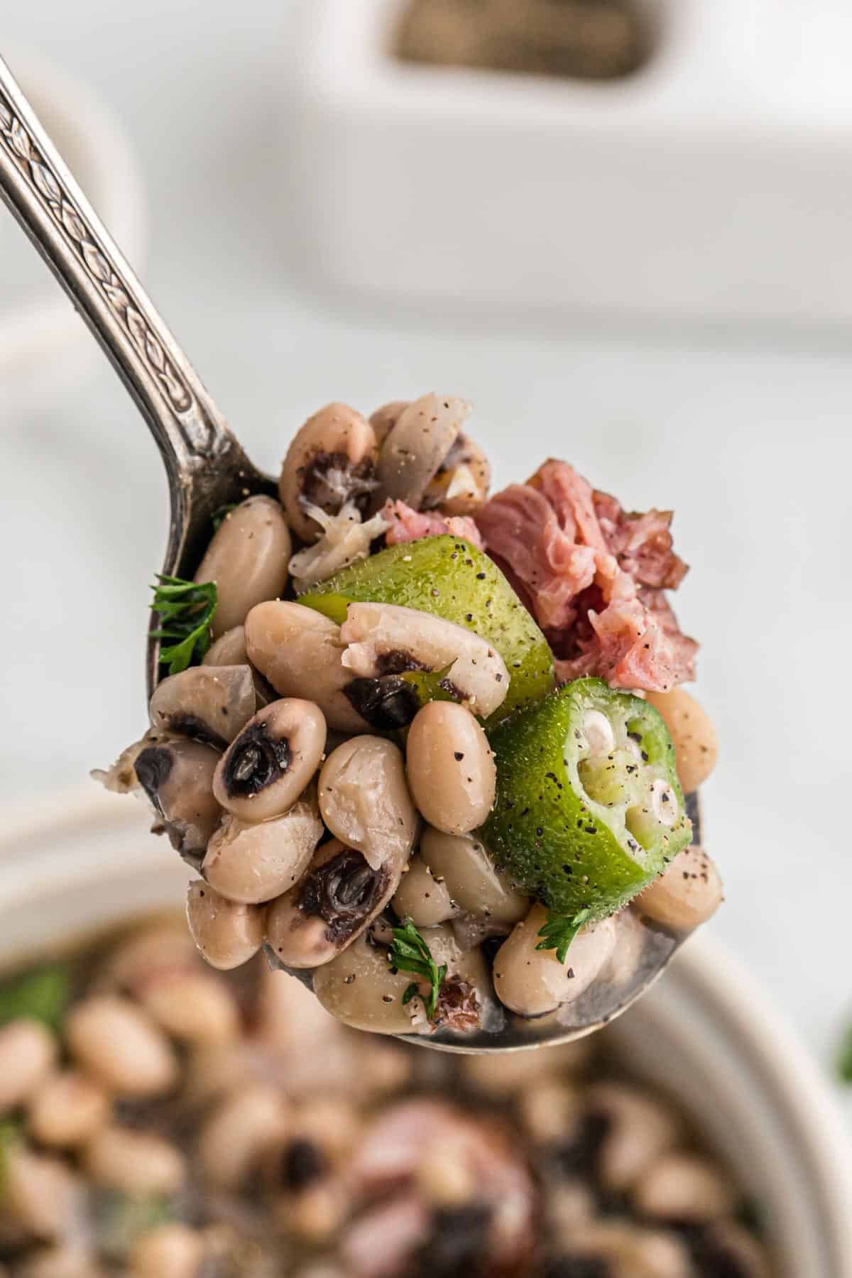 A spoonful of black eyed peas with ham.