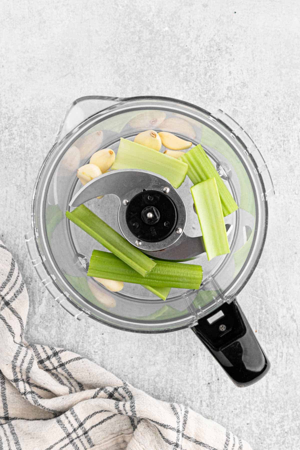 Celery and garlic in a food processor to chop.