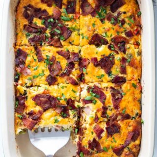 Breakfast bake recipe is cut into squares with a spatula ready to serve for brunch
