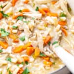 Creamy chicken noodle soup in large pot ready to serve