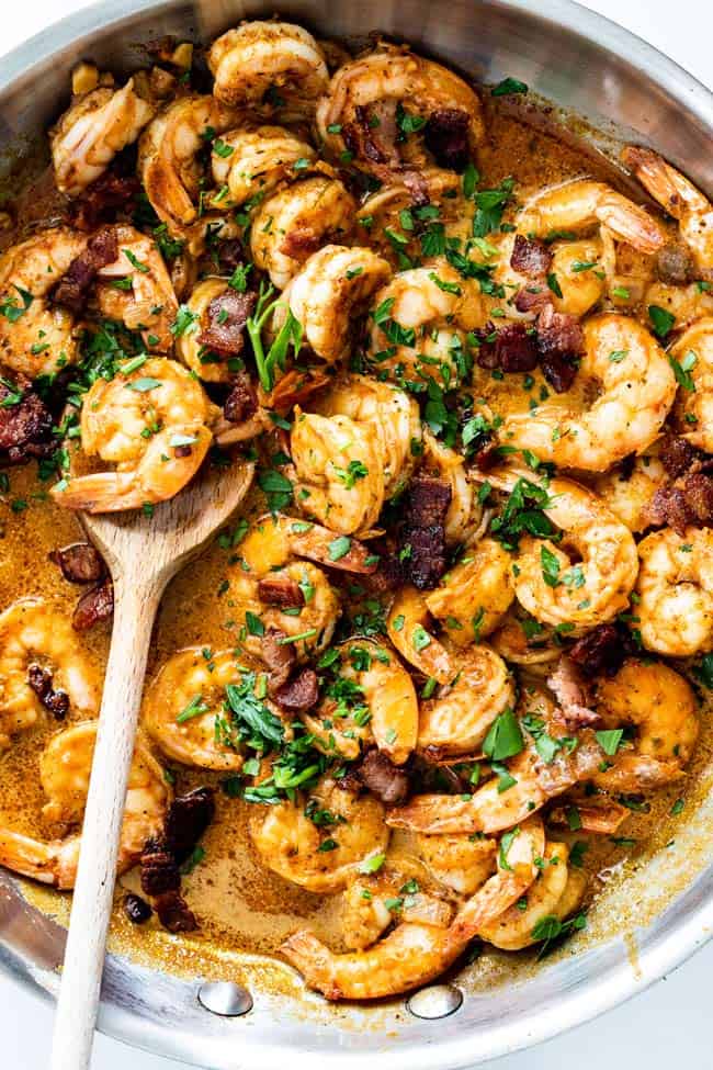 A delicious creamy keto sauce with fresh shrimp and bacon ready to serve over grits