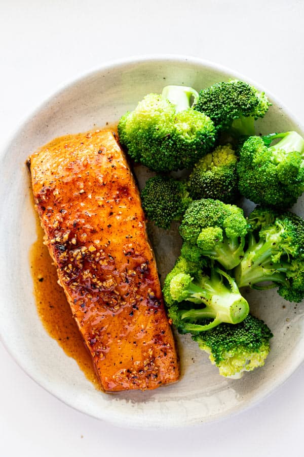 Maple salmon filet served next to steamed broccoli for weeknight dinner