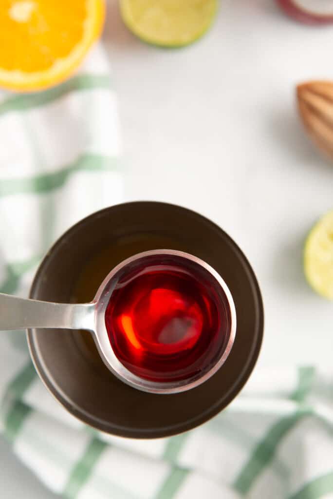 Grenadine going into a shaker to make a cocktail