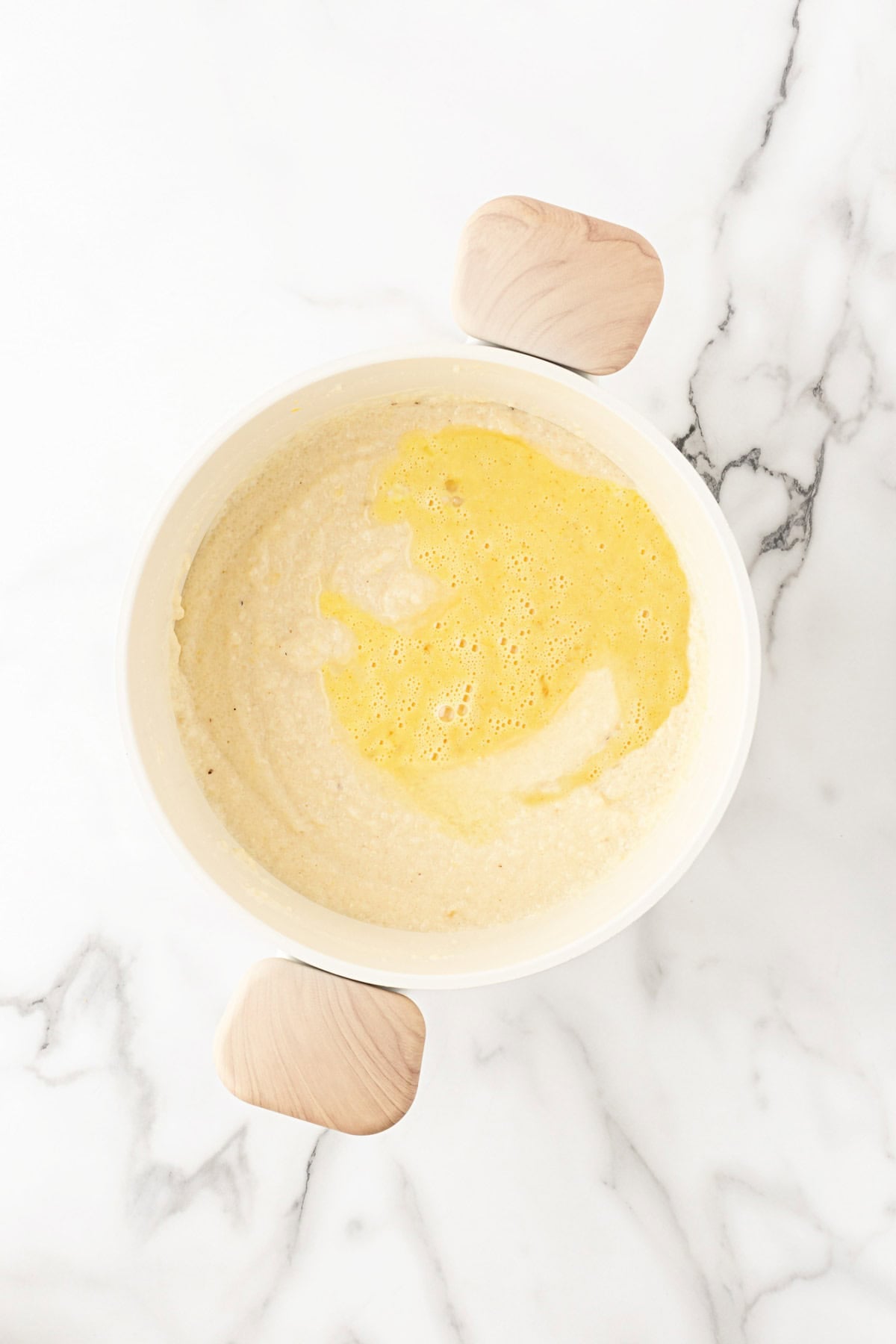 Beaten eggs added to the creamy grits mixture