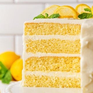 Closeup of the cut lemon layer cake, showing its three layers of yellow cake and frosting