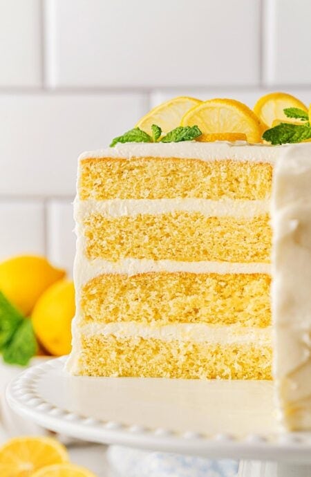 Closeup of the cut lemon layer cake, showing its three layers of yellow cake and frosting