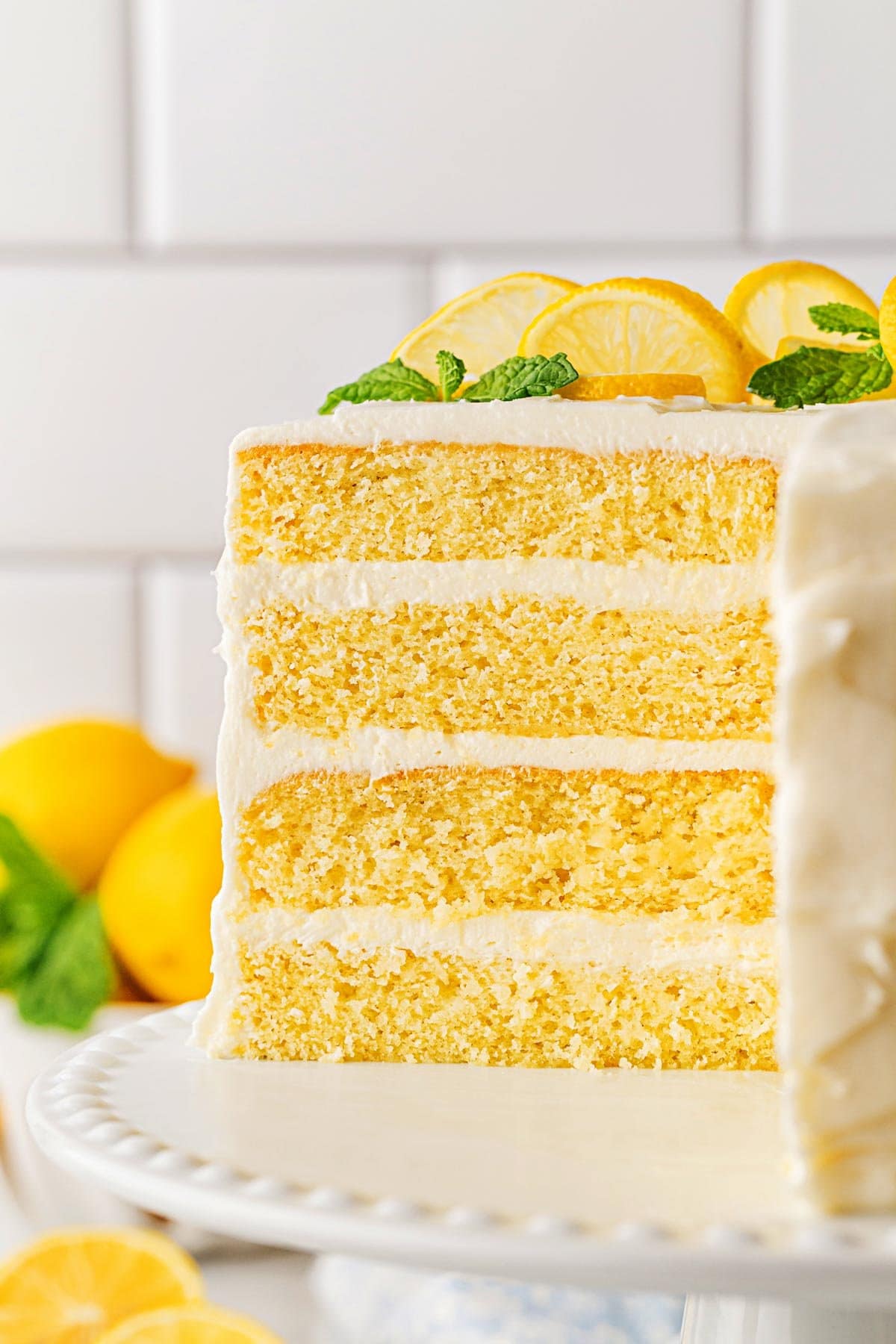 Closeup of the cut lemon layer cake, showing its three layers of yellow cake and frosting
