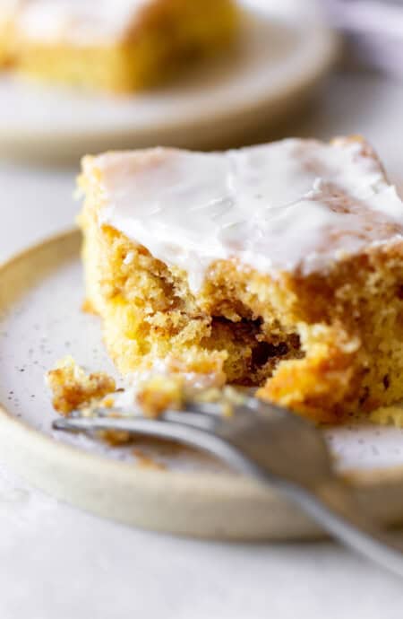 Fork eating a slice of honeybun cake