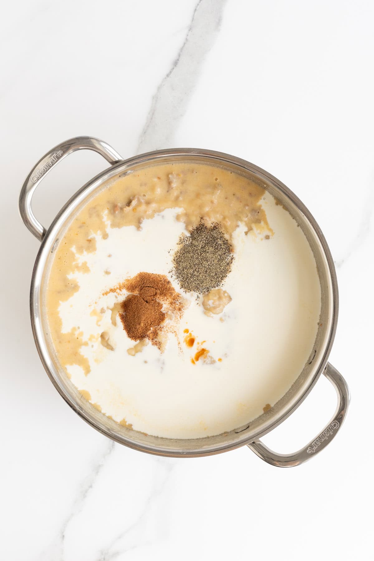 Cream, pepper, Tabasco, and nutmeg added to the thickened sausage gravy