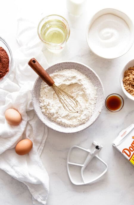 Baking Substitutions ingredients like flour, sugar and eggs scattered around