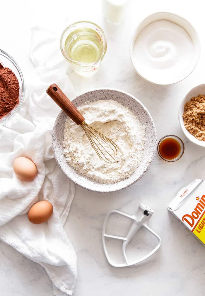 Baking Substitutions ingredients like flour, sugar and eggs scattered around