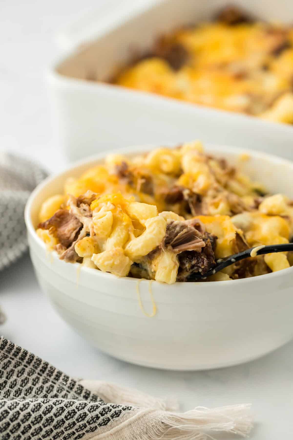 A close up of a bowl of brisket mac ready to enjoy