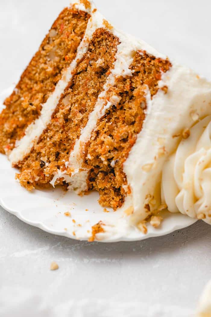 A slice of the best carrot cake with a bite taken out