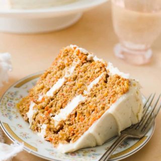 A giant slice of carrot cake recipe on vintage plate with fork ready to serve