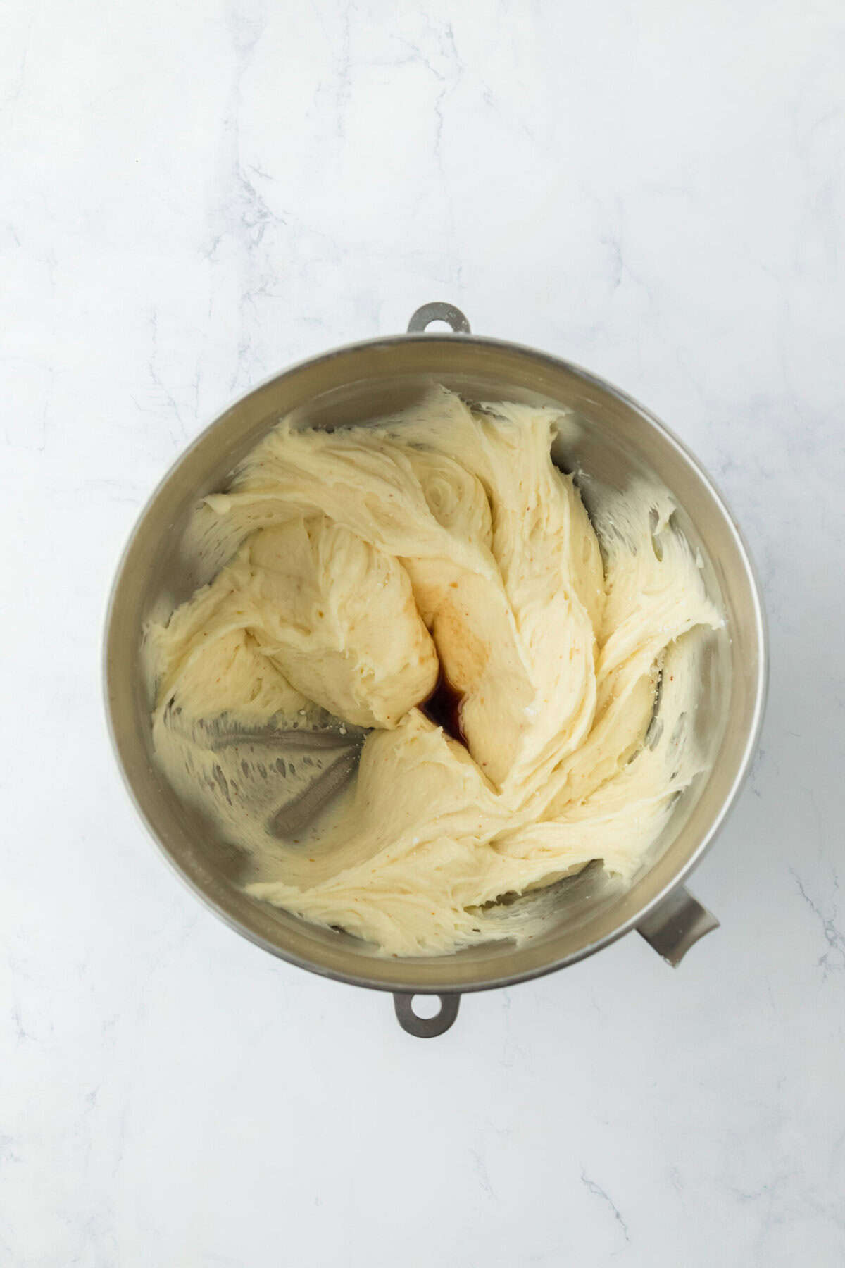 Salt and vanilla being added to a stand mixer