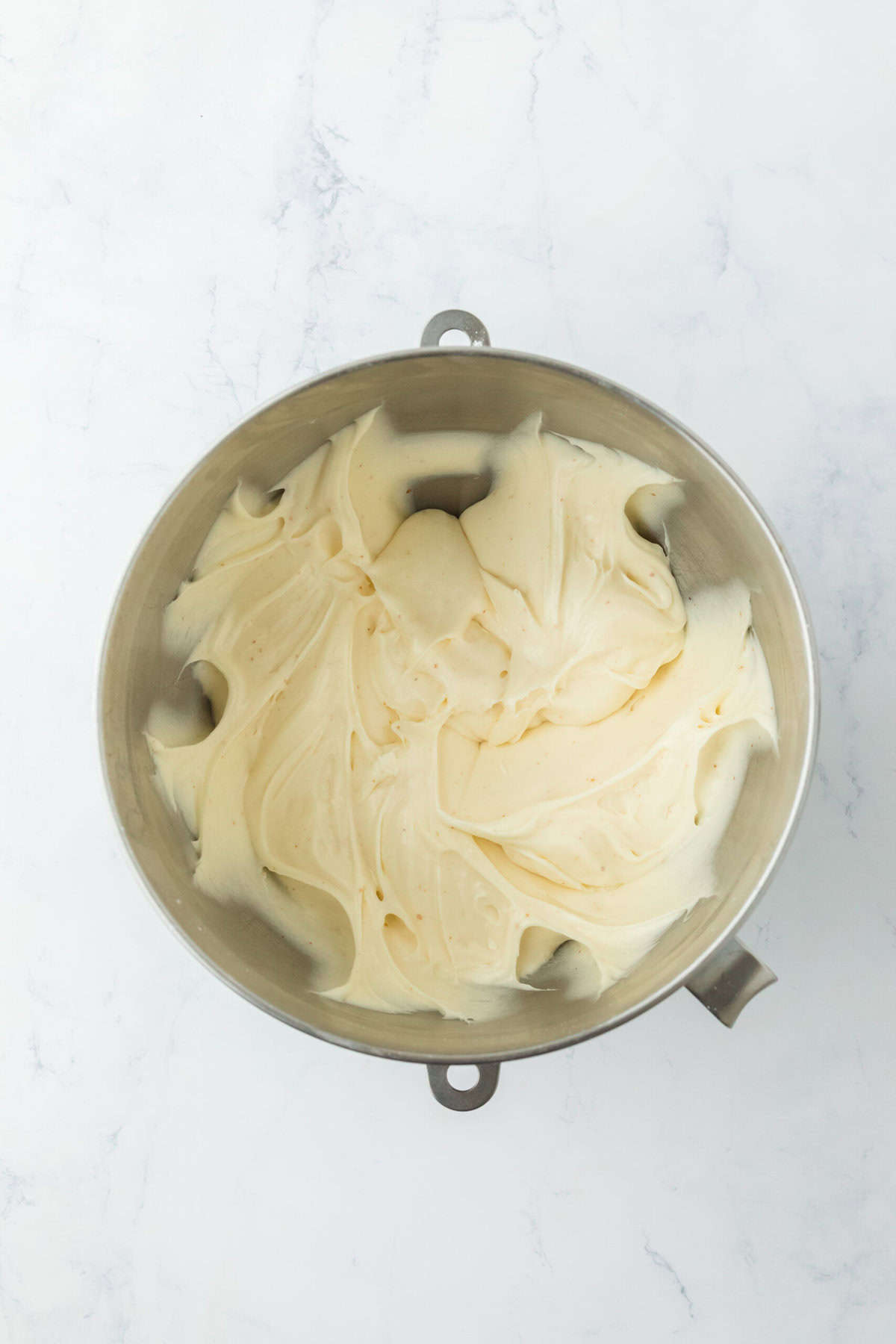 Smooth brown butter cream cheese frosting in a stand mixer bowl