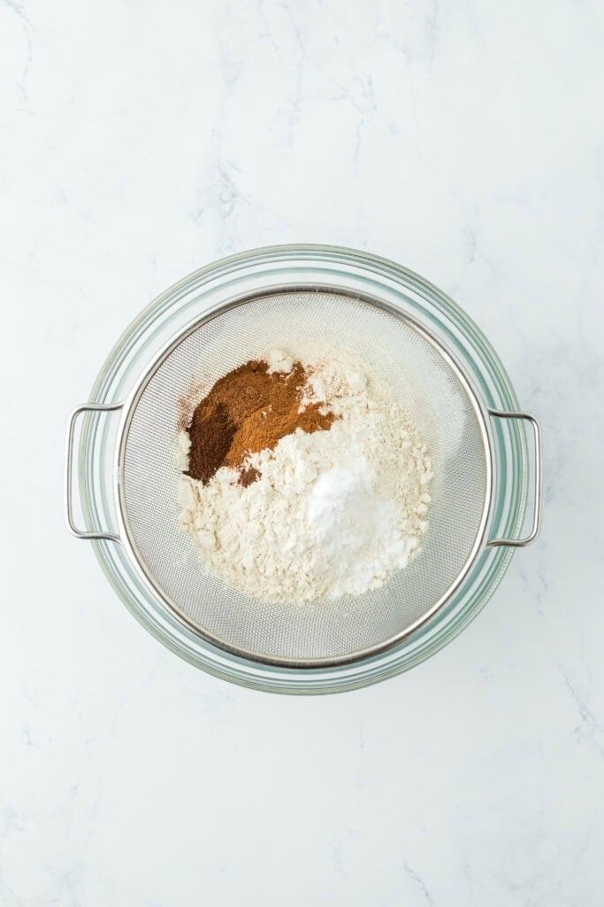 Flour, spices and baking soda sifted into a bowl