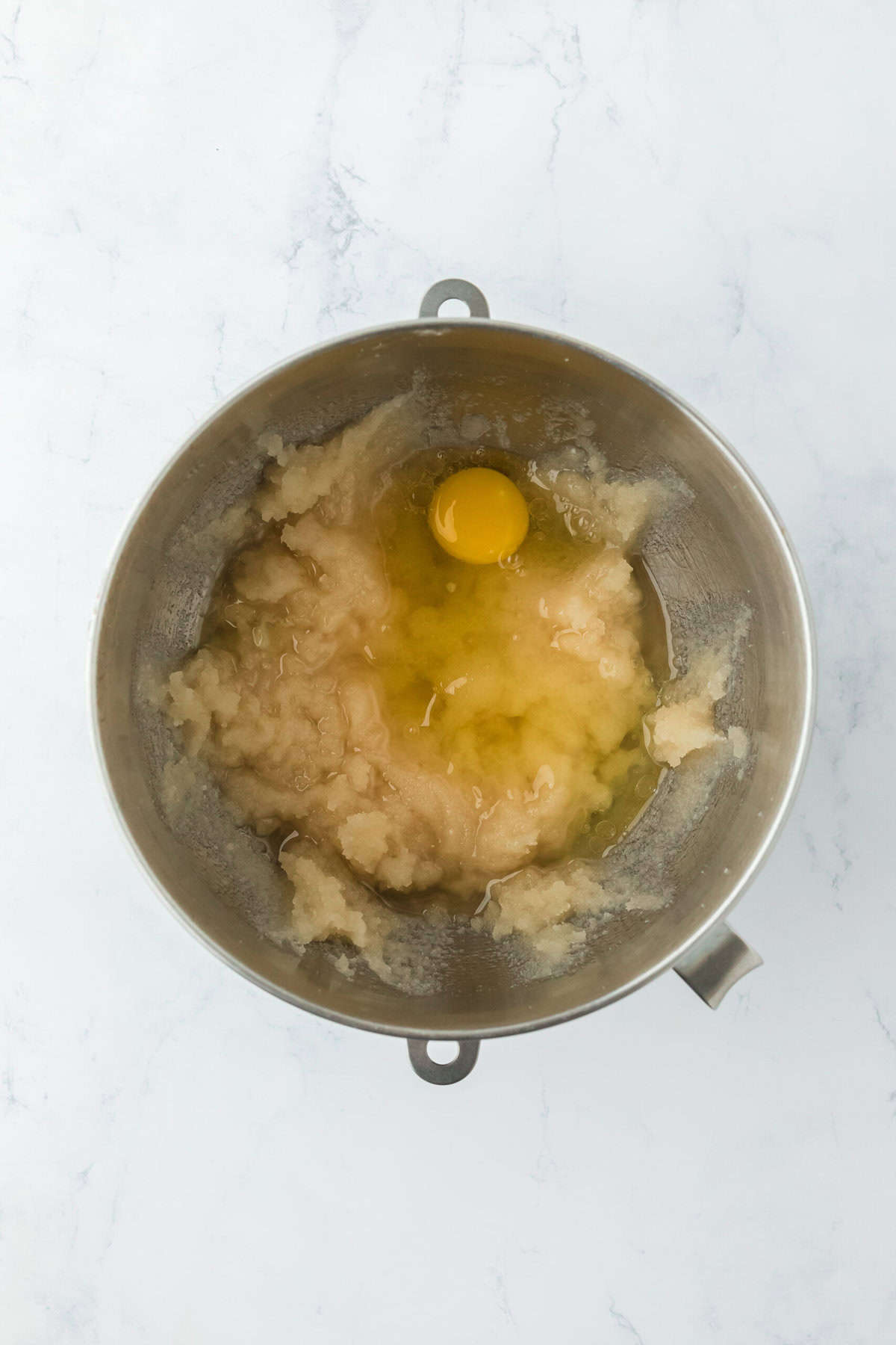 Eggs being added to stand mixer bowl to make cake batter