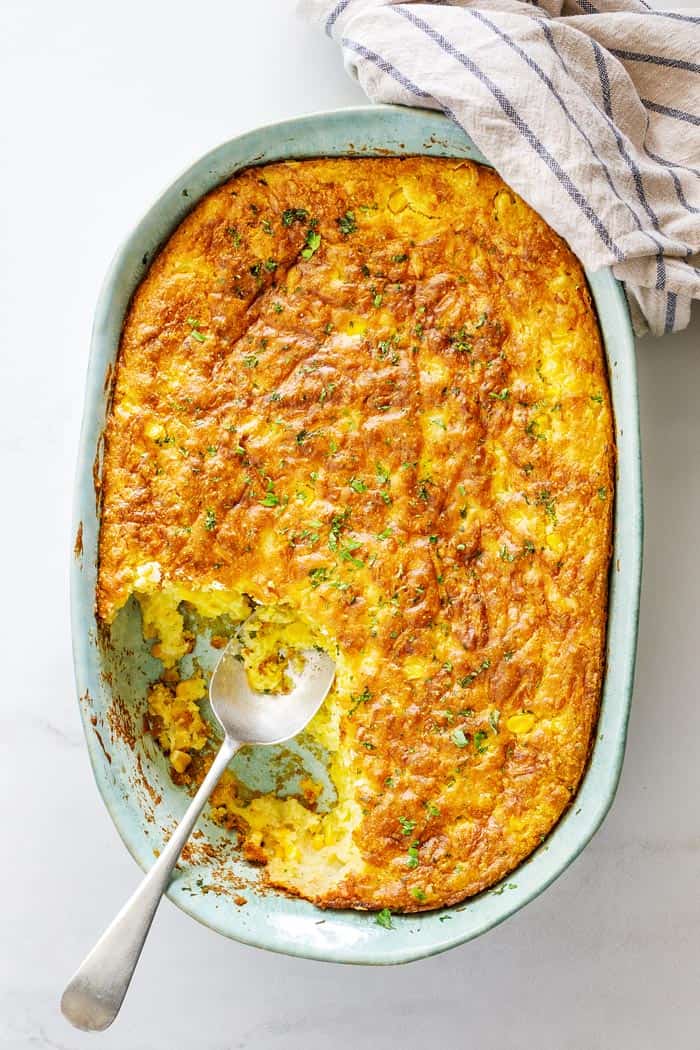 Baked corn spoonbread being served during a meal