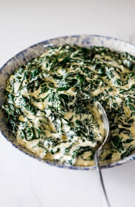 A delicious bowl of perfectly creamed spinach ready to serve with dinner