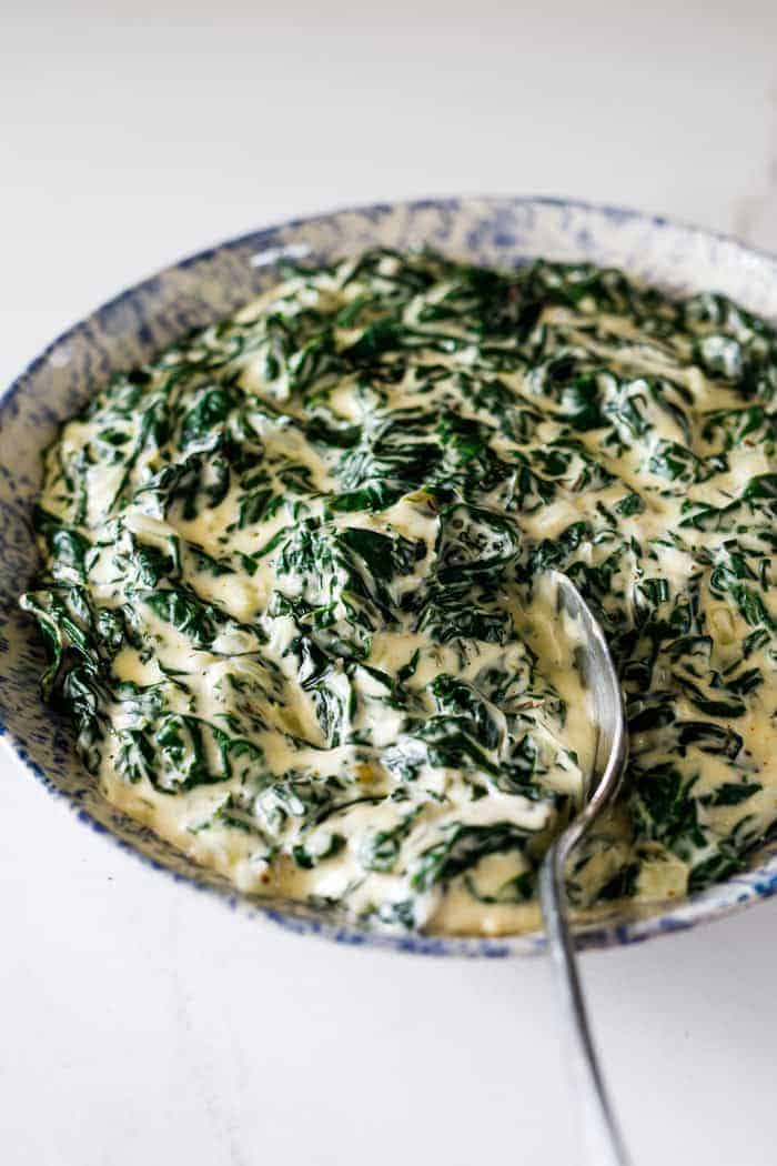 A delicious bowl of perfectly creamed spinach ready to serve with dinner