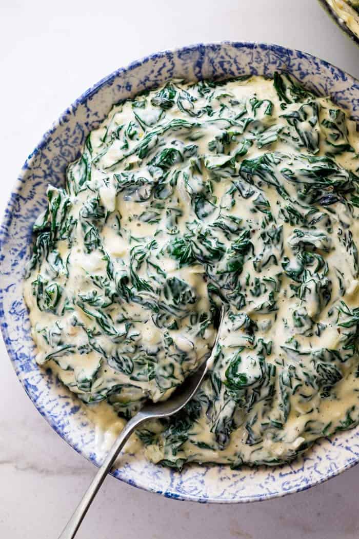 A delicious serving bowl filled with creamed spinach ready to serve