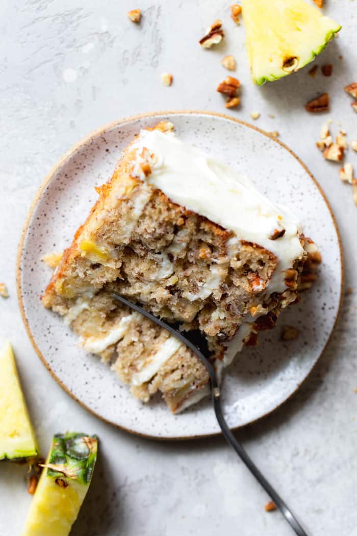 A slice of the best hummingbird cake recipe being eaten with a fork