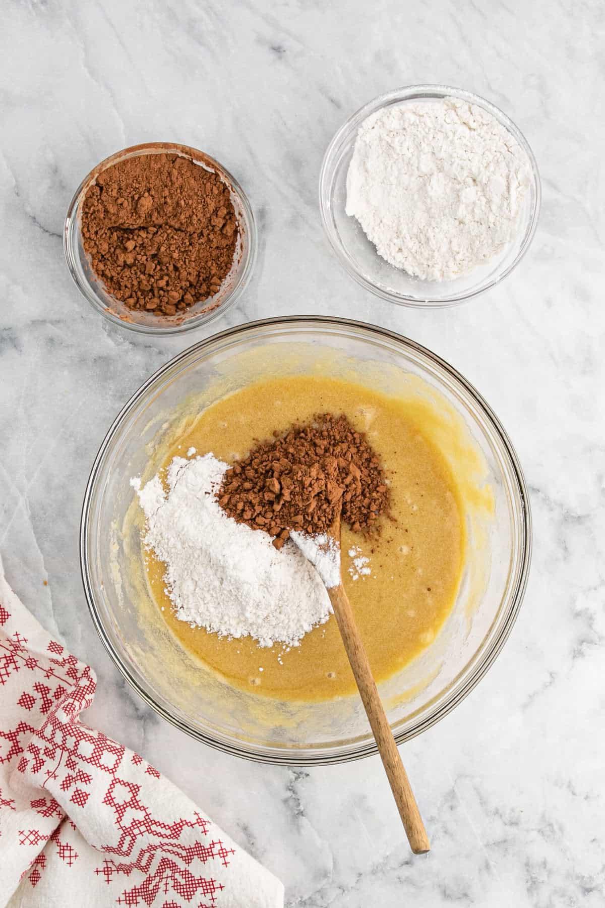 Flour and cocoa powder added to brownie batter