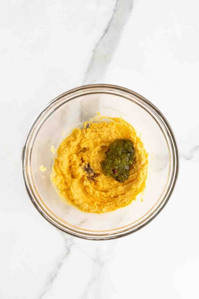 Relish and black pepper added to egg yolk mixture