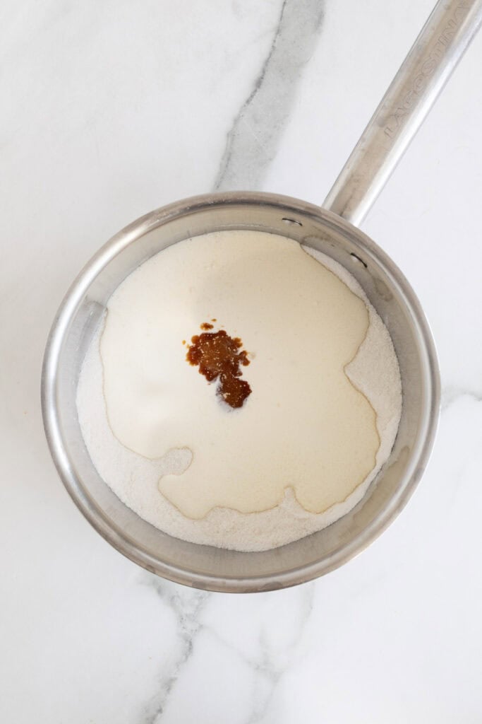 Heavy whipped cream and vanilla added to a pot