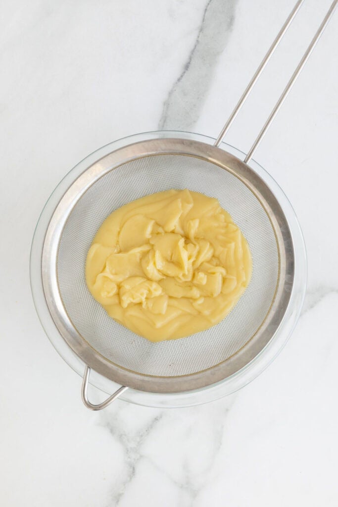 Vanilla pudding being strained